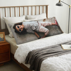 Custom portrait body pillow cover styled across a bed