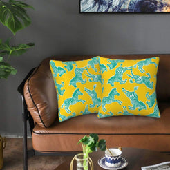 Velvet pillow covers with yellow and teal zebras, styled on a sofa
