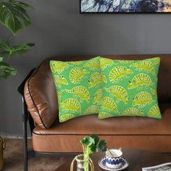 Velvet pillow covers with green armadillos, styled on a sofa