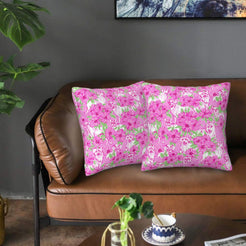 Velvet pillow covers with hot pink playful animals and flowers, styled on a sofa
