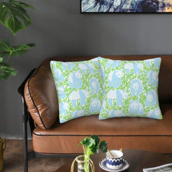 Velvet pillow covers with light blue bamboo and white animal motifs, styled on a sofa