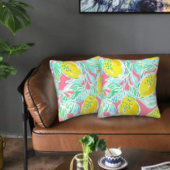 Velvet pillow covers with pink and teal lemons with leaves, styled on a sofa