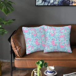 Velvet pillow covers with aqua and pink seashell pattern, styled on a sofa