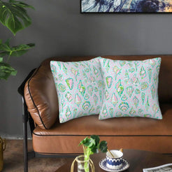 Velvet pillow covers with white pastel seashells, styled on a sofa