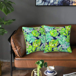 Velvet pillow covers with navy and green tropical leaves, styled on a sofa