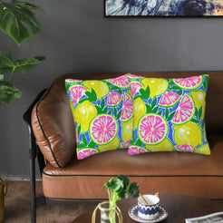 Velvet pillow covers with blue and green pink citrus slices, styled on a sofa
