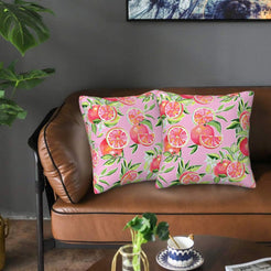 Velvet pillow covers with pink grapefruit and leaves, styled on a sofa