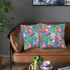 Velvet pillow covers with blue strawberries and flowers, styled on a sofa