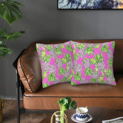 Velvet pillow covers with pink pineapples and green leaves, styled on a sofa