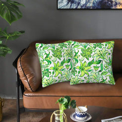 Velvet pillow covers with white and green tropical lilies, styled on a sofa