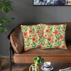 Velvet pillow covers with cream and orange lattice florals, styled on a sofa