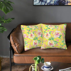 Velvet pillow covers with yellow hibiscus flowers, styled on a sofa