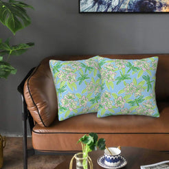 Velvet pillow covers with light blue delicate floral branches, styled on a sofa