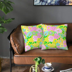 Velvet pillow covers with neon yellow and pink garden flowers, styled on a sofa