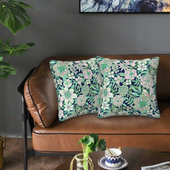 Velvet pillow covers with navy and mint botanical flowers, styled on a sofa