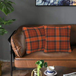 Fall velvet pillow covers with rust and brown classic plaid, styled on a brown leather sofa