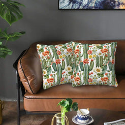 Mexican-inspired velvet pillow covers with flowering cacti on white, styled on a brown leather sofa