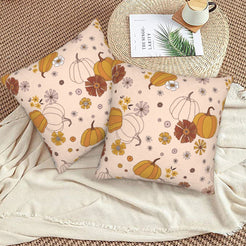 Halloween velvet pillow covers with blush pumpkins and flowers, styled on a woven chair
