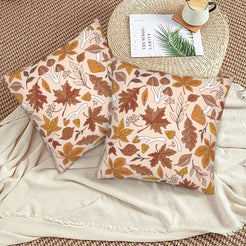 Halloween velvet pillow covers with cream autumn leaves and mushrooms, styled on a woven chair