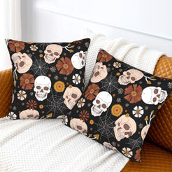 Halloween velvet pillow covers with black skulls, mushrooms, spiderwebs and flowers, styled on a sofa