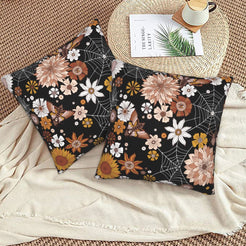 Halloween velvet pillow covers with black spiderwebs and dahlias, styled on a woven chair