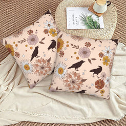 Halloween velvet pillow covers with blush ravens, moons and flowers, styled on a woven chair