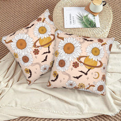 Halloween velvet pillow covers with blush daisies, cats and moons, styled on a woven chair