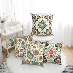 short-pile plush polyester pillow covers with cream, blue and rust paisley prints, arranged beside a white chair