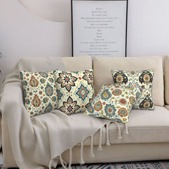 short-pile plush polyester pillow covers with cream, blue and rust paisley prints, styled on a cream sofa
