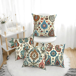short-pile plush polyester pillow covers with rust, teal and navy paisley prints, arranged beside a white chair
