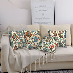 short-pile plush polyester pillow covers with rust, teal and navy paisley prints, styled on a cream sofa