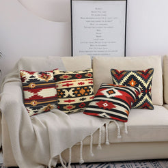 short-pile plush polyester pillow covers with black, red and cream tribal geometric prints, styled on a cream sofa