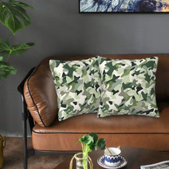 Velvet pillow covers with green and brown military camouflage, styled on a sofa