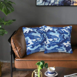Velvet pillow covers with blue camouflage, styled on a sofa