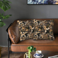 Velvet pillow covers with brown leaf camouflage, styled on a sofa
