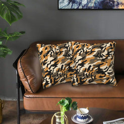 Velvet pillow covers with tan and black camouflage, styled on a sofa