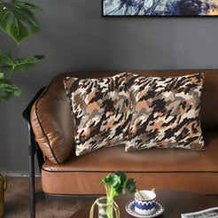 Velvet pillow covers with tan digital-style camouflage, styled on a sofa