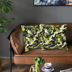 Velvet pillow covers with lime and black camouflage, styled on a sofa