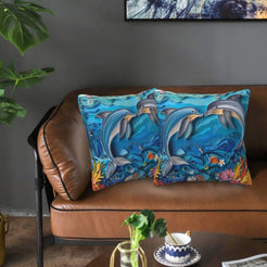 Velvet coastal pillow covers with dolphins in blue waves, styled in a living room