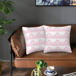 Velvet pillow covers with rows of pink bows and geometric stripes, styled on a brown leather sofa
