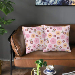 Velvet pillow covers with retro pink and brown flowers, styled on a brown leather sofa