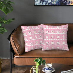 Velvet pillow covers with teddy bears and checkerboard squares, styled on a brown leather sofa
