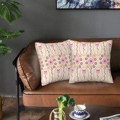 Velvet pillow covers with art nouveau tulips and hearts on cream, styled on a brown leather sofa