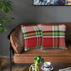 Christmas plaid velvet pillow covers with red, green and white wide tartan, styled on a brown leather sofa