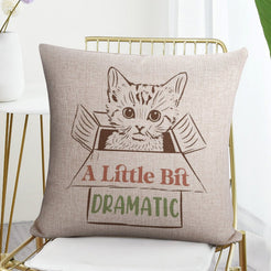 Linen-look pillow cover with cat and A Little Bit Dramatic quote, styled on a chair