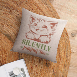 Linen-look pillow cover with cat and Silently Judging You quote, styled on a chair
