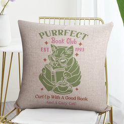 Linen-look pillow cover with Purrfect Book Club cat illustration, shown in a flat lay