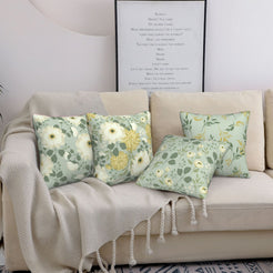 Sage floral pillow covers styled on a beige sofa