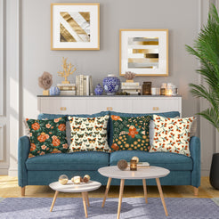 Green floral and butterfly pillow covers styled on a blue sofa