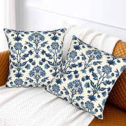 Block-print-inspired velvet pillow covers with navy tall floral stems, styled on a sofa